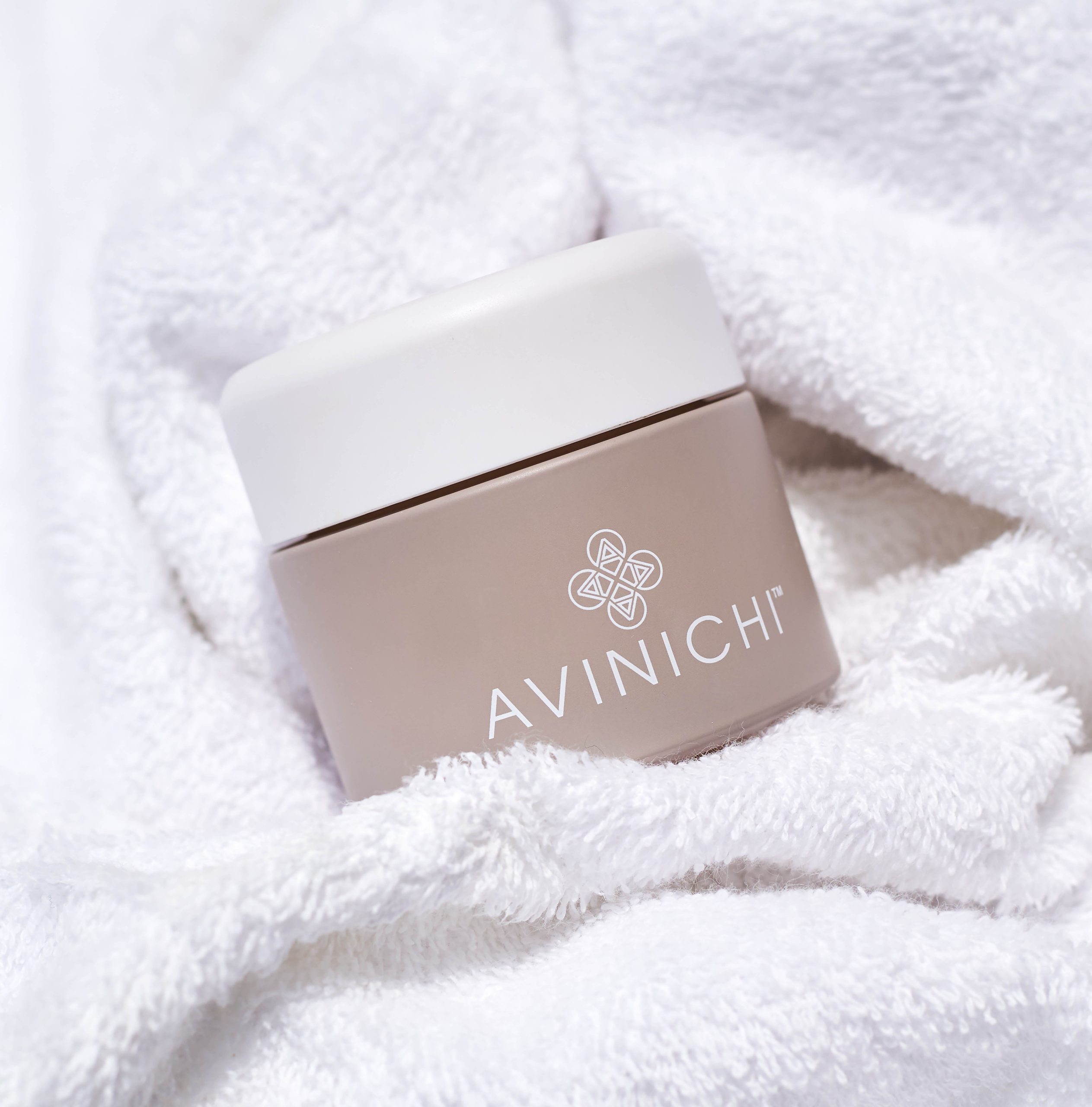 Avinichi night cream nestled in towel