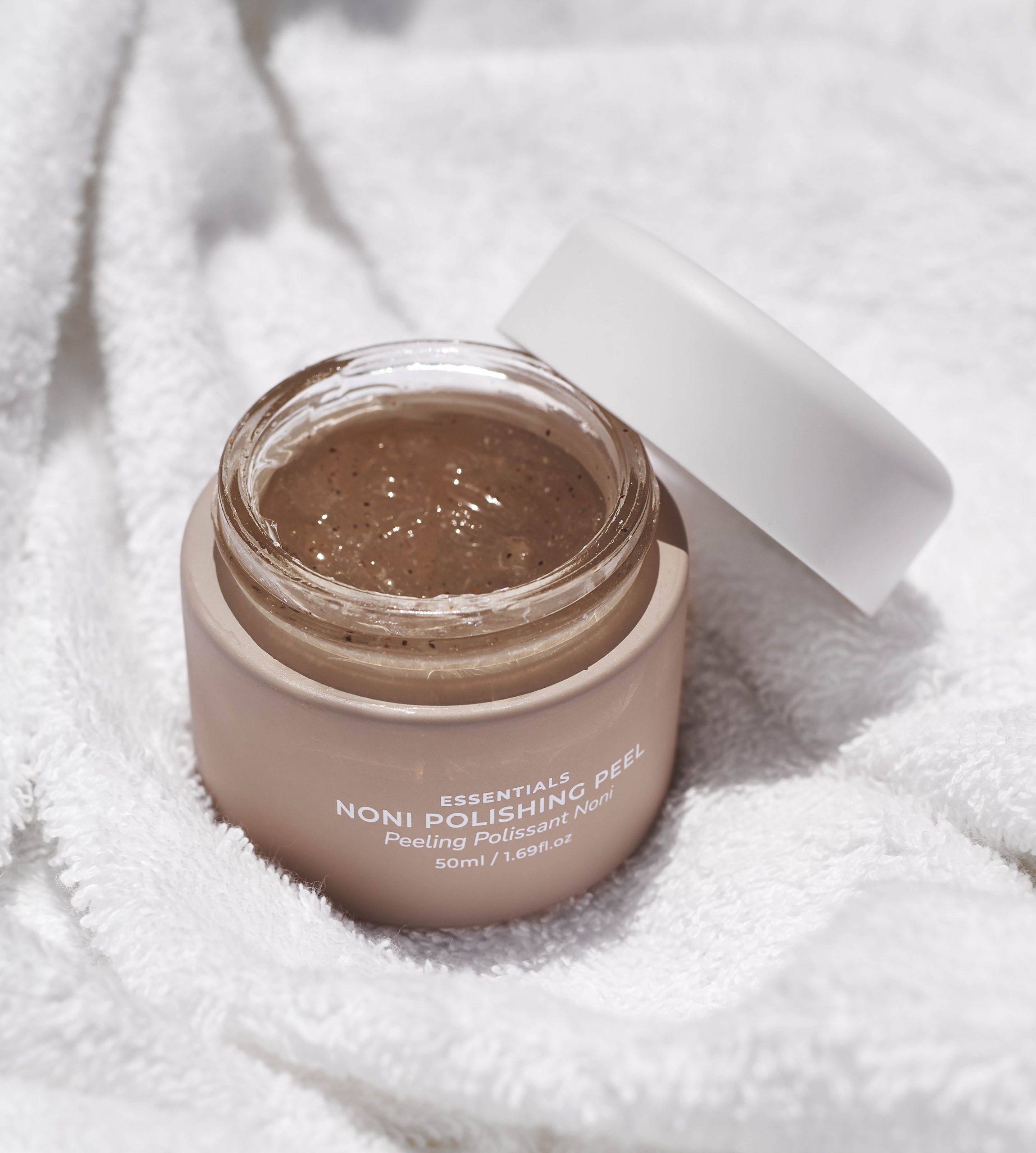 Open jar of Noni Polishing Peel on towel to help with winter skin damage