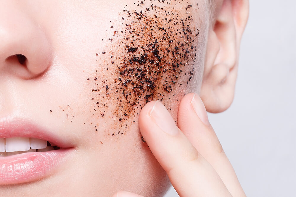 Woman using physical exfoliants