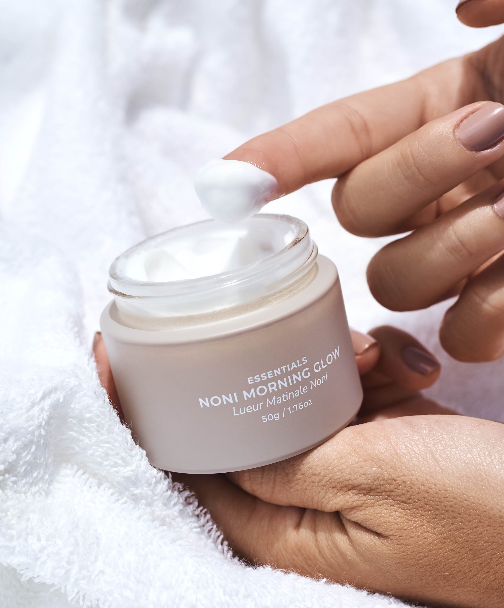 Person using the Avinichi Noni Morning Glow cream