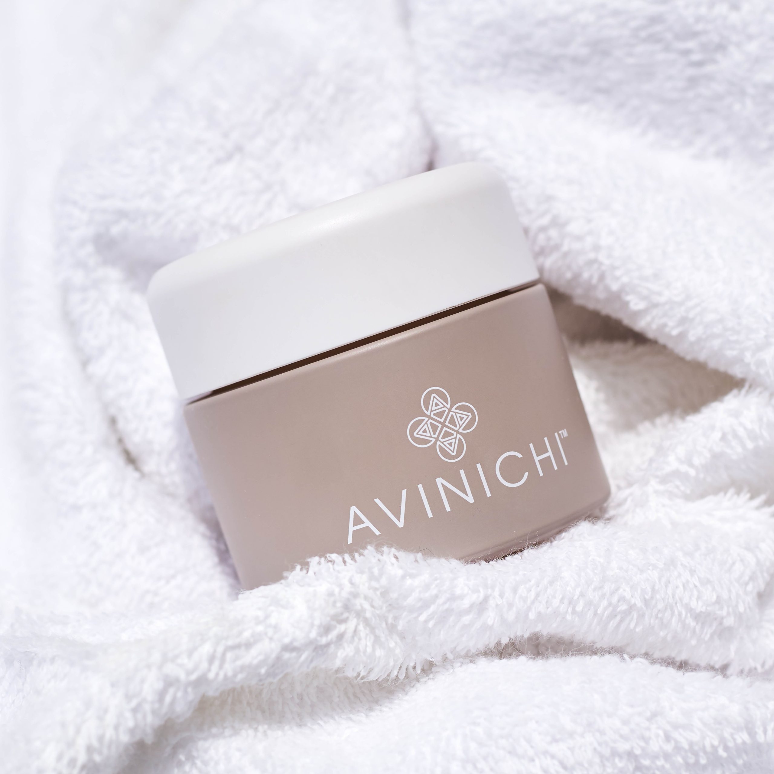 Jar of Avinichi cream wrapped in a towel