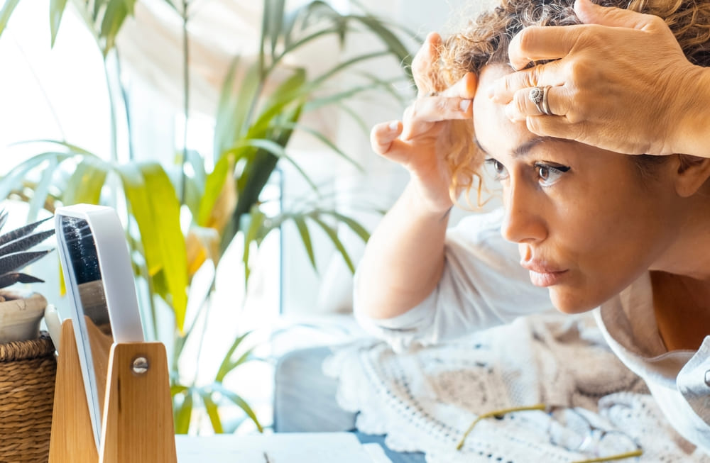 Woman examining skin for winter damage