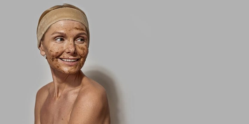 woman exfoliating face