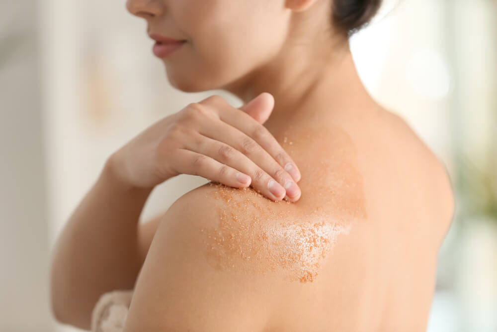 woman exfoliating body