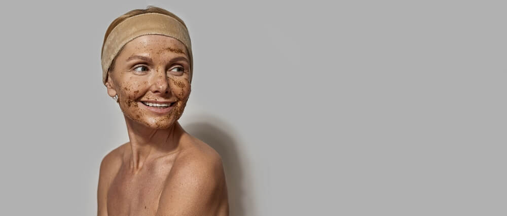 woman exfoliating face