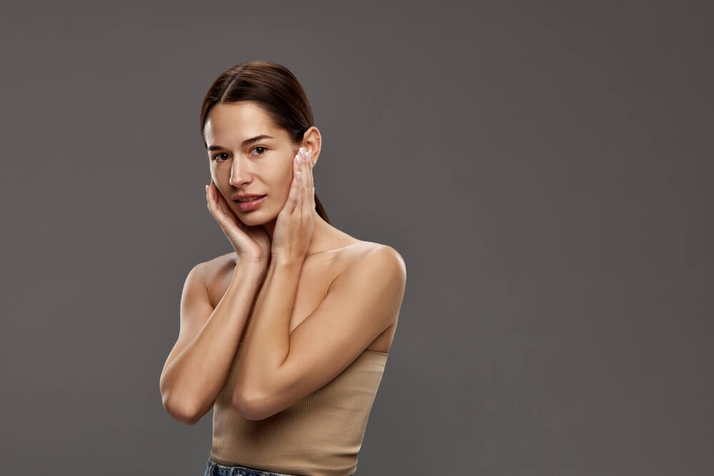 woman holding face