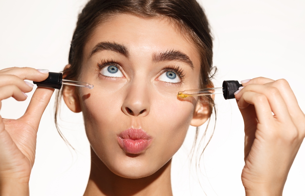 woman applying serums