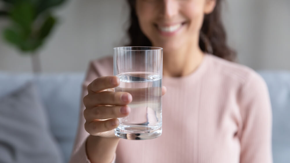 woman holding water glass