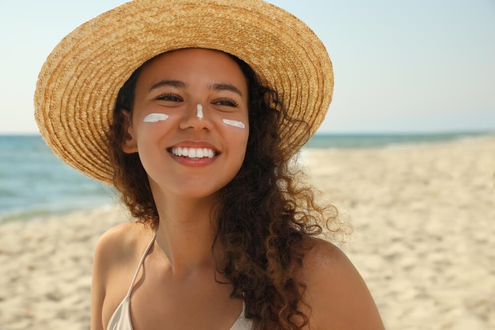 woman wearing hat and sunscreen