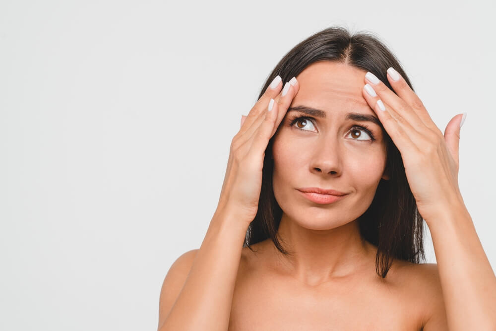 woman touching forehead